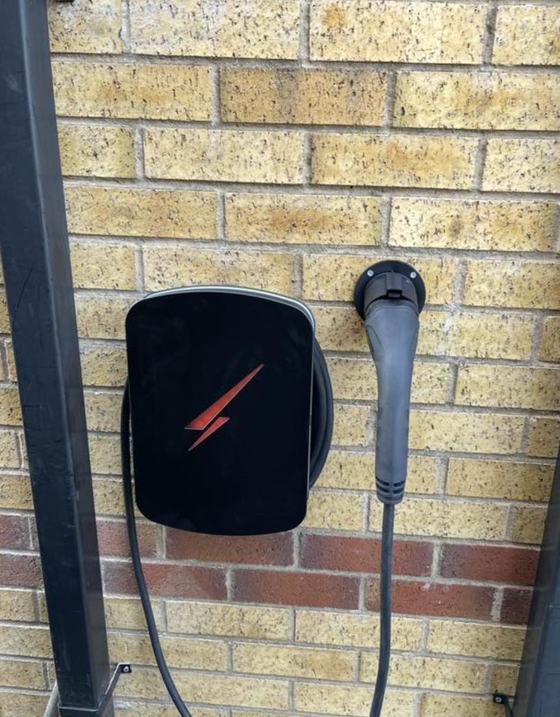 Tethered EV charger with holster