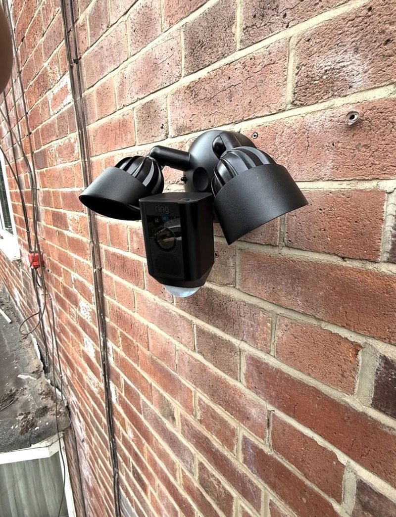 Floodlight camera on a brick wall